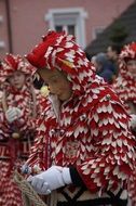 dance of people in red-white costumes at mascarade