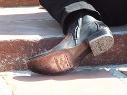 black boot on a man’s foot