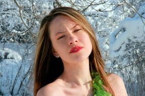 portrait of a beautiful woman among a snowy landscape