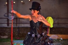 girl in a black dress on a soap bubble show