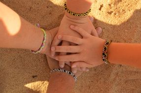 children's hands are folded on top of each other