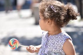 Child Girl with colorful lollipop in hand