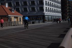 cyclist on a boardwalk in a long beach