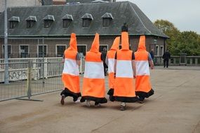 Orange and white costumed people on the street in Antwerp, Belgium