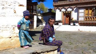 child with father on the street, bhutan