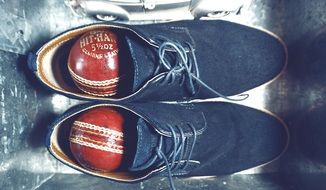 blue men's shoes with baseballs