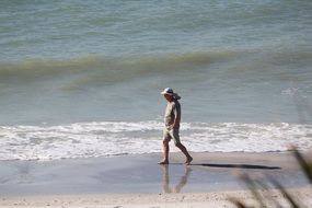 man walks on the beach