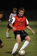 soccer player with the ball on the field during the match