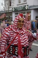 persons in carnival costumes with Pig Bubbles on street, germany