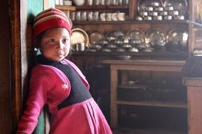 girl in a pink and black dress in the house in Nepal