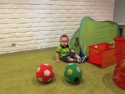 little child plays in the playroom