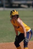 softball player girl in yellow uniform