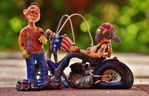tattooist and biker as figures in the park