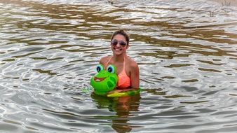 woman with swimming ring in water