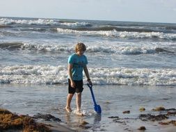 boy goes along the coastline
