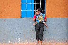 Mother with child in piggyback