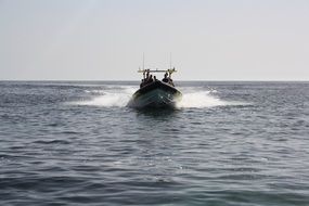 people in the boat are sailing on the sea