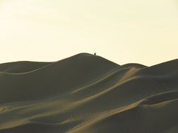 People are working on the dune in the desert