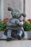 sculpture depicting a girl with a ball