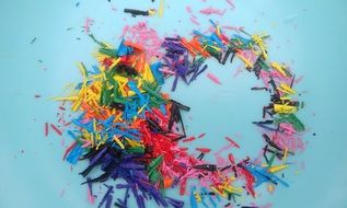 Crayons shavings at blue background