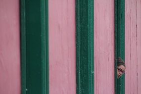 looking girl in the window of a colorful facade