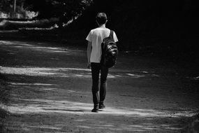 man with rucksack is a black and white photo