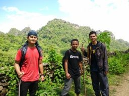 three young asian men with sticks at path, Lebanon, bakka