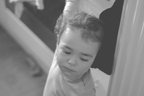 black and white photo of a pensive child