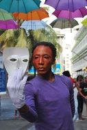 street actor with a white mask