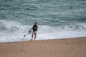 man windsurfer on the beach