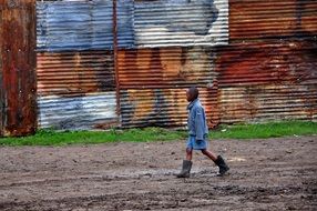 African child on a background of corrugated sheet