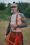 man in traditional costume with feathers