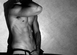 black and white photo of a male torso after training