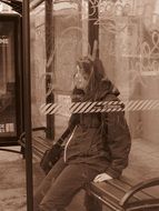 man at the bus stop in monochrome image