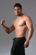 smiling muscular man posing without a t-shirt