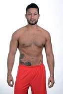 smiling muscular man posing without a shirt