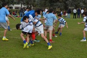 children in sports teams on the football field