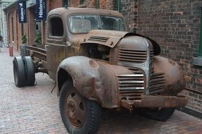 Old vintage car near the brick building