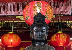 Buddha statue on the red-light background