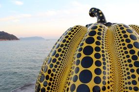 yellow spotted pumpkin on a background of the sea