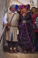 happy middle age man and woman in medieval costumes
