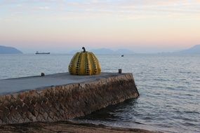 pumpkin sculpture on pier in japan