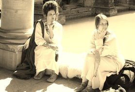 women in ancient Roman dresses