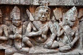 figures of warriors on the wall of the temple in Cambodia