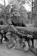 black and white image of a big figure in a temple complex