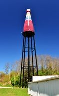 high water tower near the trees