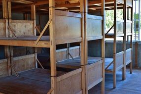 wooden hard beds in two tiers in a concentration camp