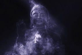 smoky silhouette of the beautiful buddha statue in the dark