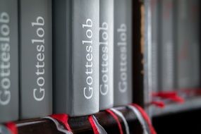 gray prayer books on the shelf