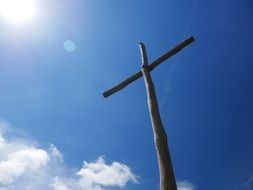wooden catholic cross against blue sky